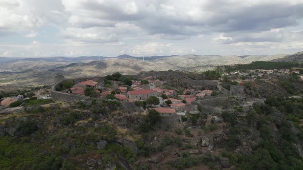 Scenic stone Village on remote location, Mountain range background, Sortelha. Upwards pullback