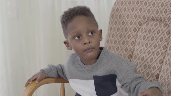 Portrait Of Funny African American Child Boy Chewing Gum Or Candy
