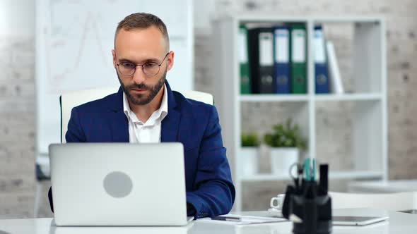 Confident Male Office Worker Wearing Lawyer Glasses Working Using Laptop Pc Looking at Screen alt