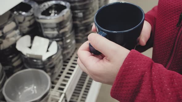 Girl in Gloves Against Virus Buys Blue Mug for Hot Tea and Coffee in Store