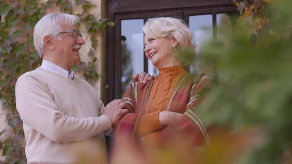 Handsome senior couple embracing in autumn park