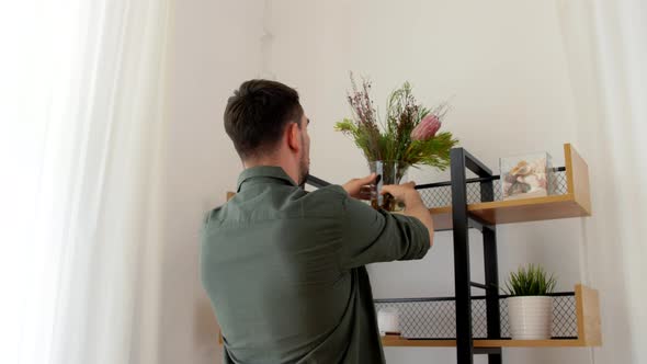 Man Decorating Home with Flower or Houseplant alt