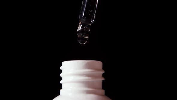 Closeup of Serum Drops Falling From the Pipette