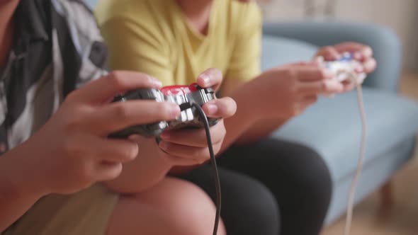 Close Up Children's Hands Holding Joystick Game Play Video Game At Home alt