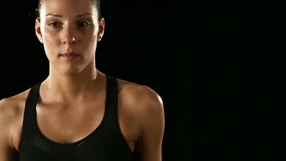 Young Athletic Sweaty Woman Wearing Sporstwear is Waiting Isolated on Black