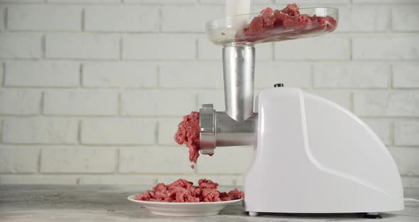 Cooking Raw Minced Meat at Home on a Meat Grinder. alt