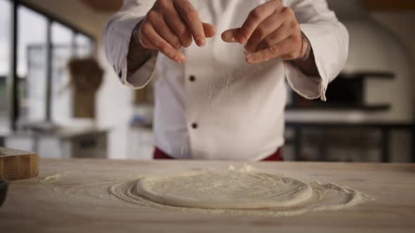Chef Hands Making Pizza in Kitchen alt
