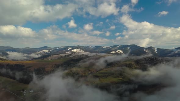 Flying Over a Mountain Landscape in the Clouds alt