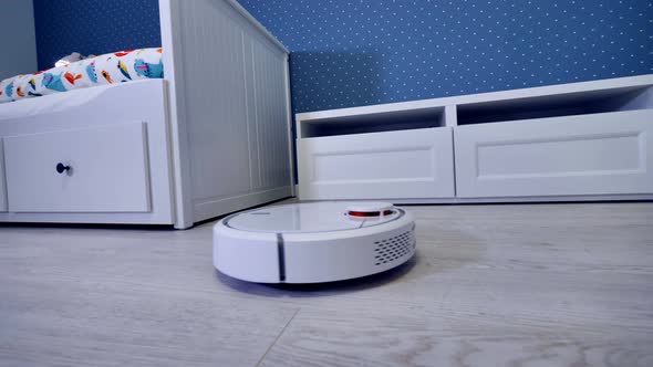 A Robotic Vacuum Cleaner Starts Its Routine From the Door alt