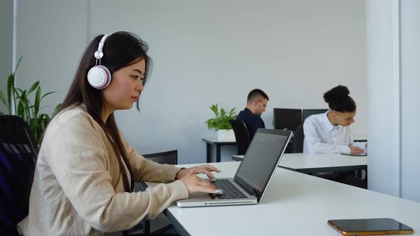 Asian Woman Working in Open Space Office alt