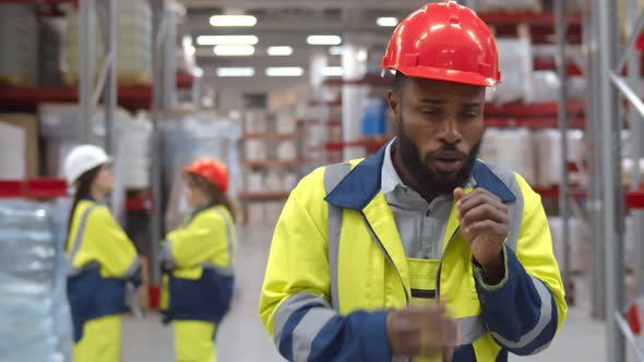Young African Manager Coughing and Feeling Sick in Warehouse alt