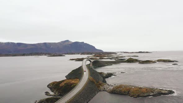 Car Driving On The Epic Atlantic Ocean Road. Storseisundet Bridge In Norway. Aerial alt
