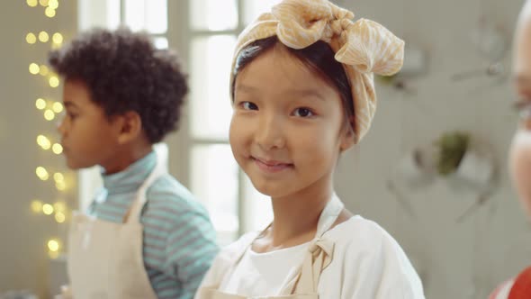 Portrait of Cheerful Asian Girl on Culinary Masterclass alt