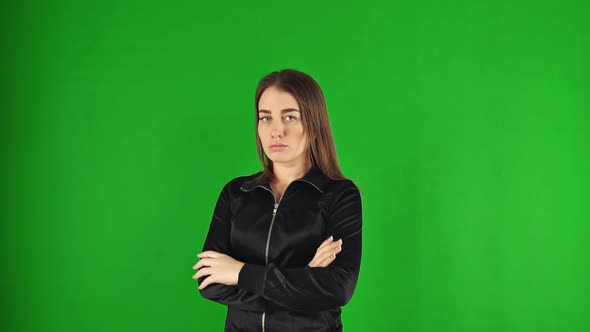 Young Offended Girl with Crossed Arms, Isolated on Green Screen