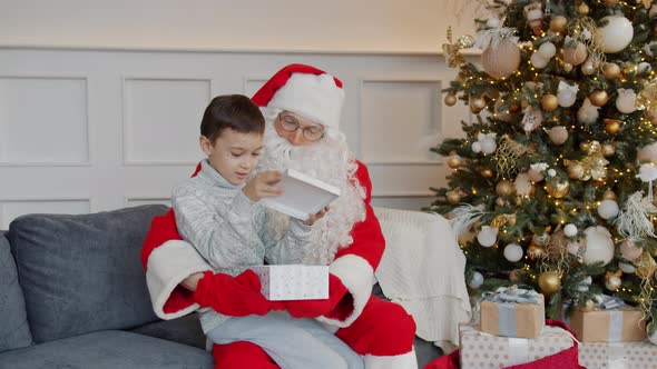 Slow Motion of Kid Unpacking Santa's Present and Getting Smartphone on Holiday alt