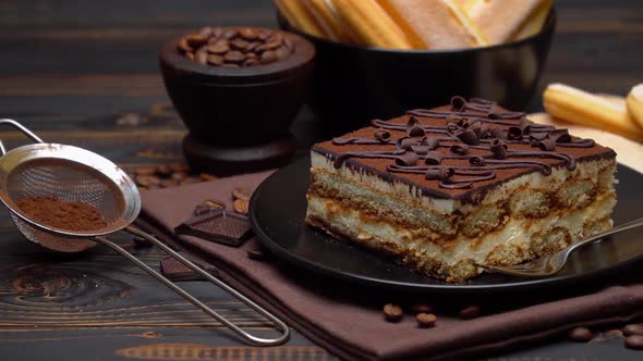 Portion of Traditional Italian Tiramisu Dessert Coffee Beans and Savoiardi Cookies alt