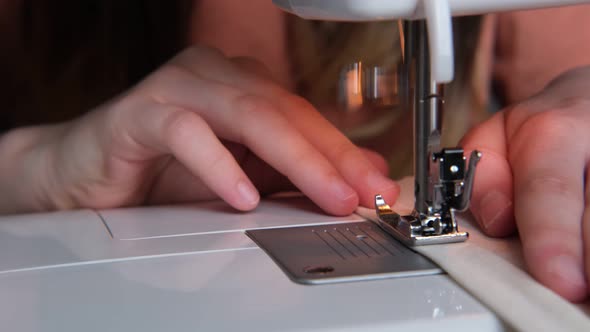 Little Girl Teenager Sews a Bag on a Sewing Machine Hands Closeup