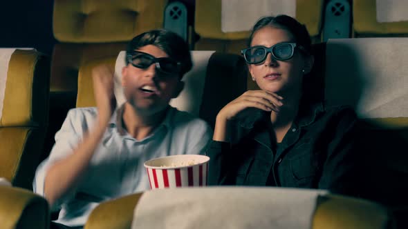 Man and Woman in the Cinema Watching a 3D Movie alt