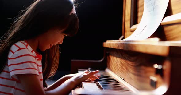 Schoolgirl learning piano in music class 4k, Stock Footage | VideoHive