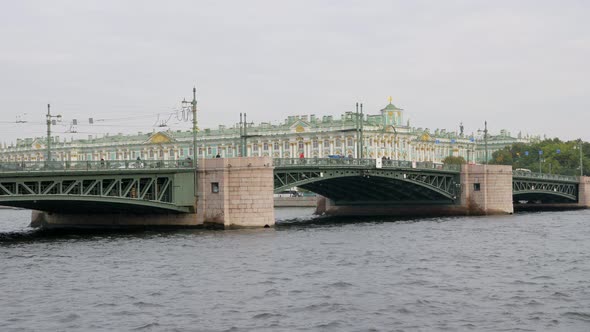 People Walking and Cars Are Moving on Palace Bridge Over Neva River in Saint Petersburg
