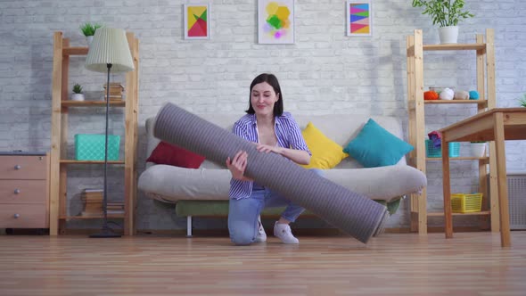 Young Woman Brings a New Carpet alt