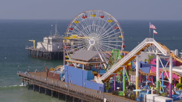 Aerial of Ferris wheel and amusement park rides at Pacific Park alt
