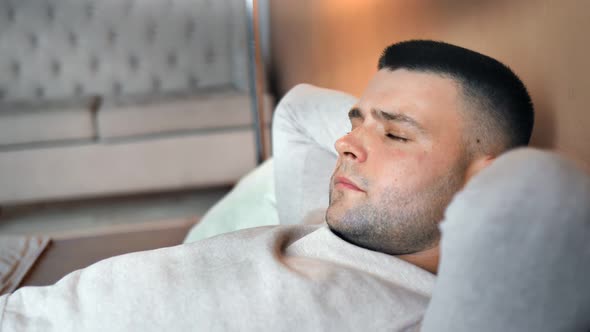 Closeup Tired Caucasian Man Lie on Bed with Closed Eyes Trying to Sleeping on Softness Pillow alt