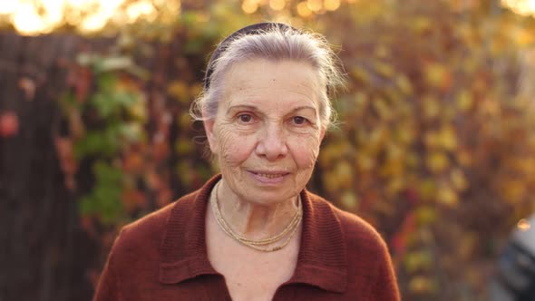 Happy Old Woman on Nature alt