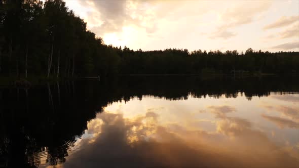 beautiful sunset reflecting on a lake in finland alt