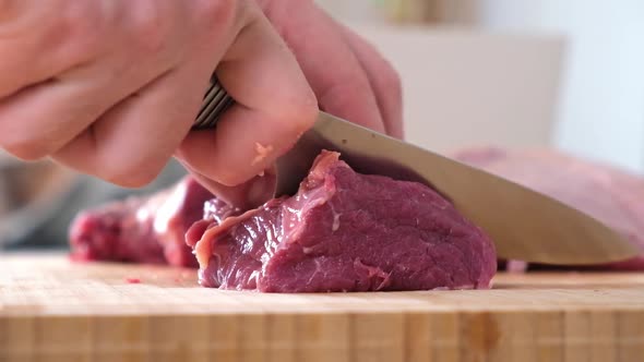 Man Cuts Meat with Knife on Wooden Board Preparation Minced Beef Pork for Cutlets Meatballs Chops