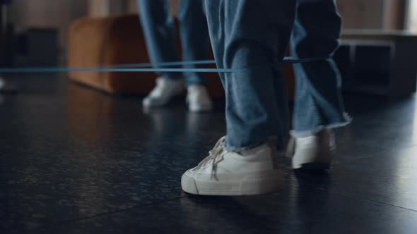Closeup Legs Children Playing Rubber Band Game alt
