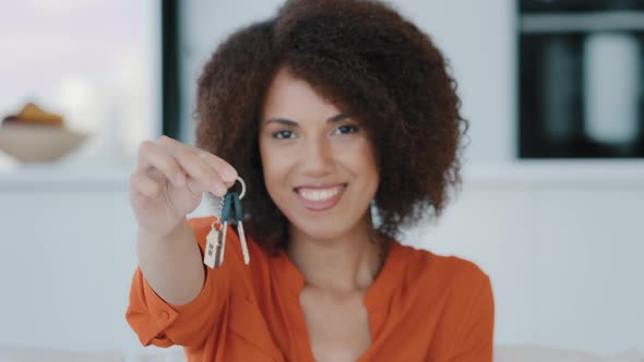 African American Happy Woman Holding Key Buying Own Home Real Estate alt