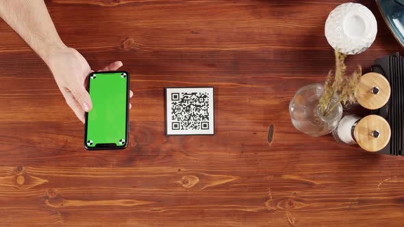 Woman Using Smartphone with Chroma Green Screen Top View Online Menu in Cafe alt