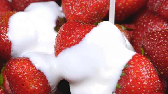 Yogurt Falling on Fresh Strawberries