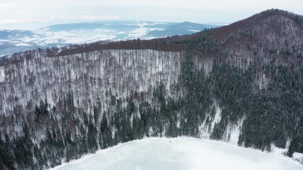 Aerial View Of Frozen Lake Sfanta Ana In The Volcanic Crater Of Ciomadul Volcano At Winter In Harghi alt