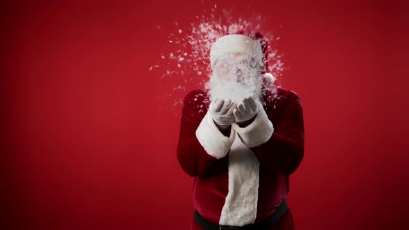 Santa Claus Blowing Snow off His Palms alt