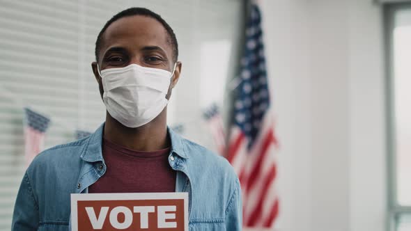 Video of black man in face mask with voting card. Shot with RED helium camera in 8K. alt