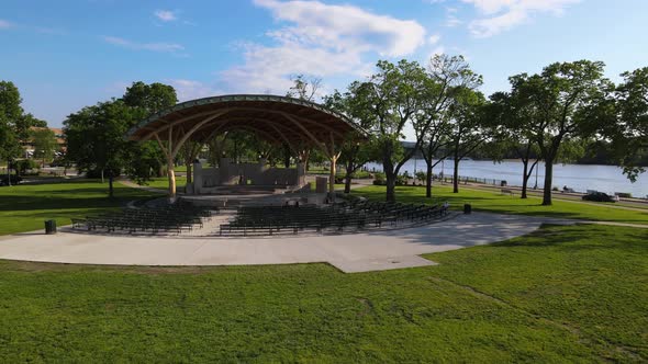 Aerial view of bandshell in midwest park along Mississippi River on a bright sunny day.