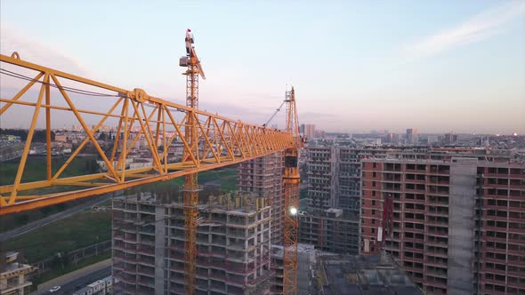 Aerial View Of Construction Crane With Cityscape Background In The Morning alt