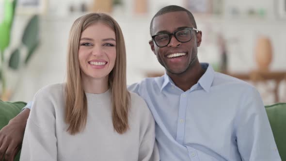 Happy Mixed Race Couple Smiling at the Camera Home alt