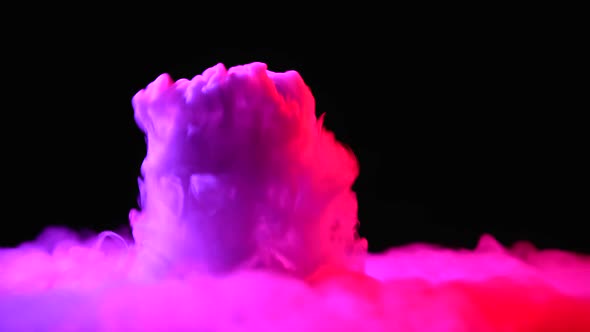 Glass with the Effect of Dry Ice with Pink Light on Black Background at Studio alt