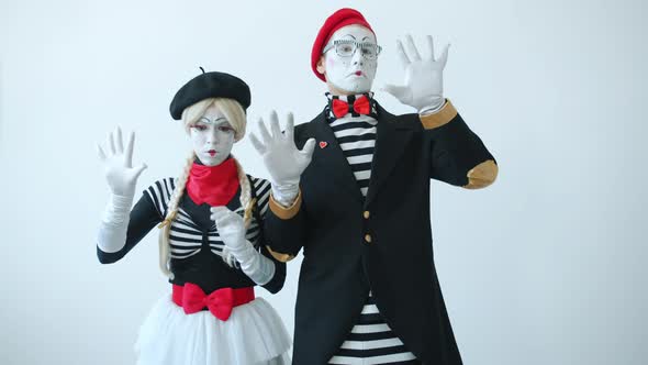 Couple of Mimes Touching Imaginary Wall Looking for Escape Then Opening Invisible Door Leaving alt