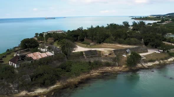 Aerial camera shot of the coast with ruins of Fort James at Saint John's, Antigua and Barbuda alt
