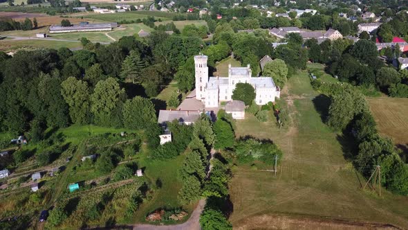 Vecauce Manor in Latvia Aerial View of the Pink Castle Through the Park. Vecauce Castle Tower With a alt