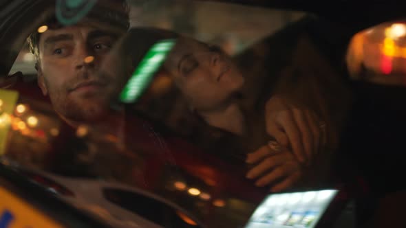 Man Hugging a Girl in the Back Seat of a Car