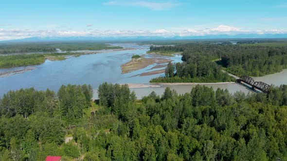 4K Drone Video of Alaska Railroad Train Trestle with Mt. Denali in Distance during Summer alt