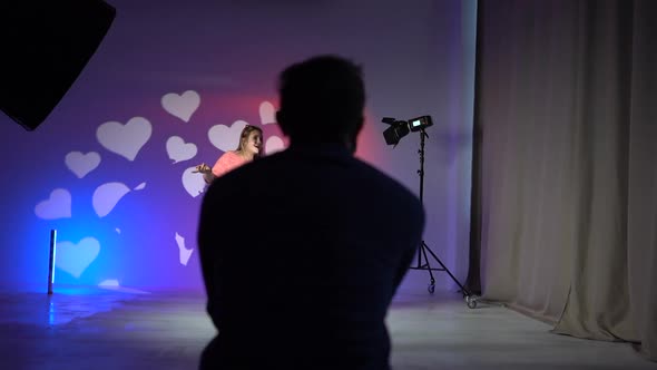 Unrecognizable Video Operator Shoots a Portrait of Two Girls Dancing in Neon Light alt