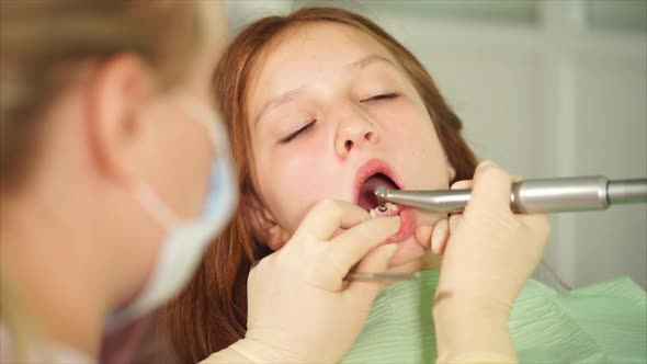Teenager is Waiting for the Completion of Dental Treatment of Teeth in Hospital alt