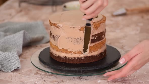 Covering Layer Cake With Frosting Or Cream.