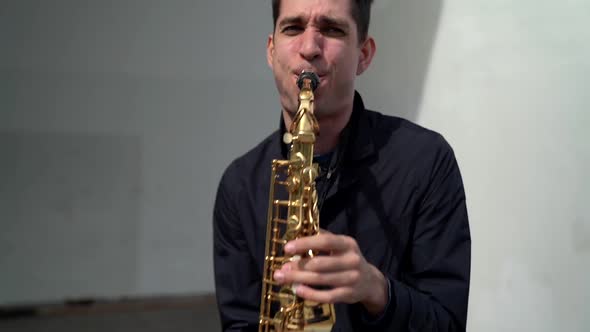 Jazz Musician Is Playing Saxophone on City Street at Sunny Day, Young Man Is Performing Song alt